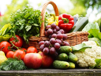 Fresh organic vegetables in wicker basket in the garden