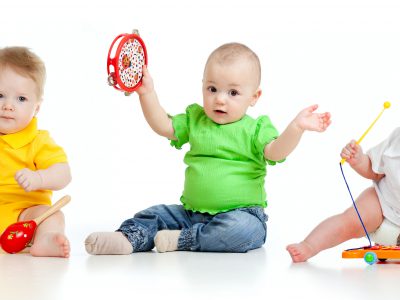 Children playing with musical toys. Isolated on white background